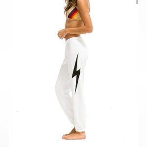 White aviator sweatpants with a black lighting bolt. Size xs